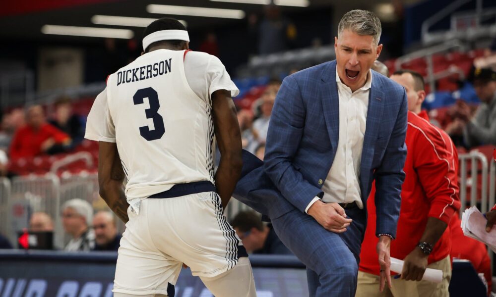 Robert Morris forward Amarion Dickerson and head coach Andy Toole celebrate during a game during the 2025 season -- RMU Athletics