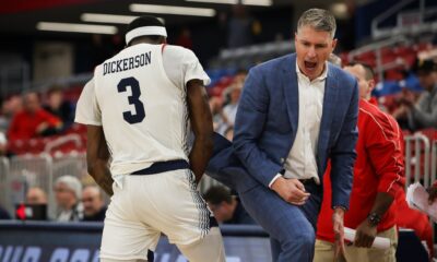 Robert Morris forward Amarion Dickerson and head coach Andy Toole celebrate during a game during the 2025 season -- RMU Athletics