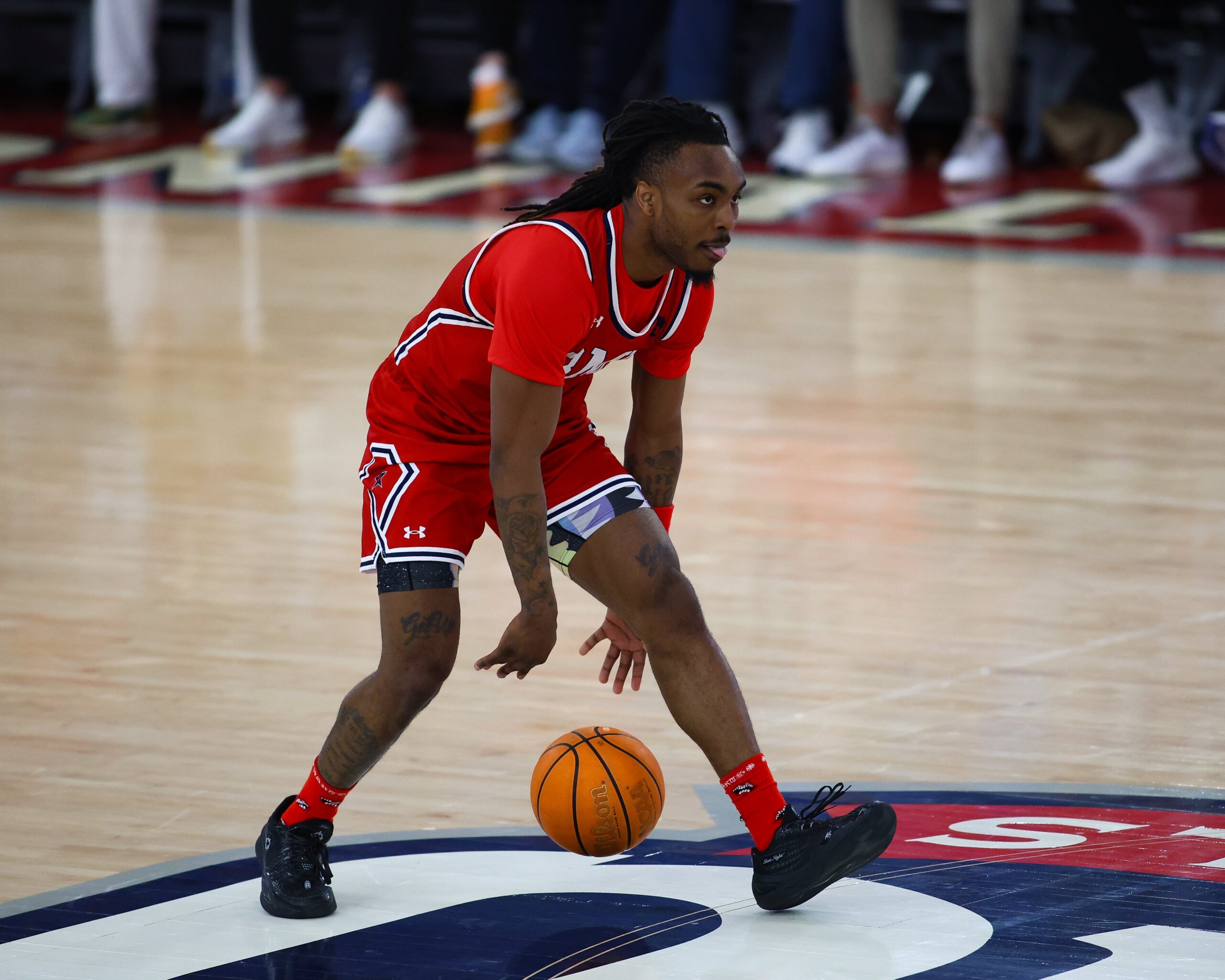 Robert Morris guard Kam Woods dribbles the ball up the court at the UPMC Events Center -- RMU Athletics