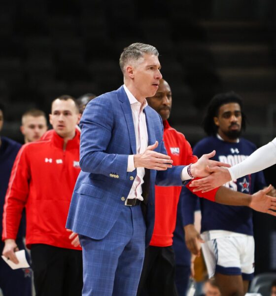 Robert Morris head coach Andy Toole gives a high-five to Ryan Prather Jr. -- RMU Athletics
