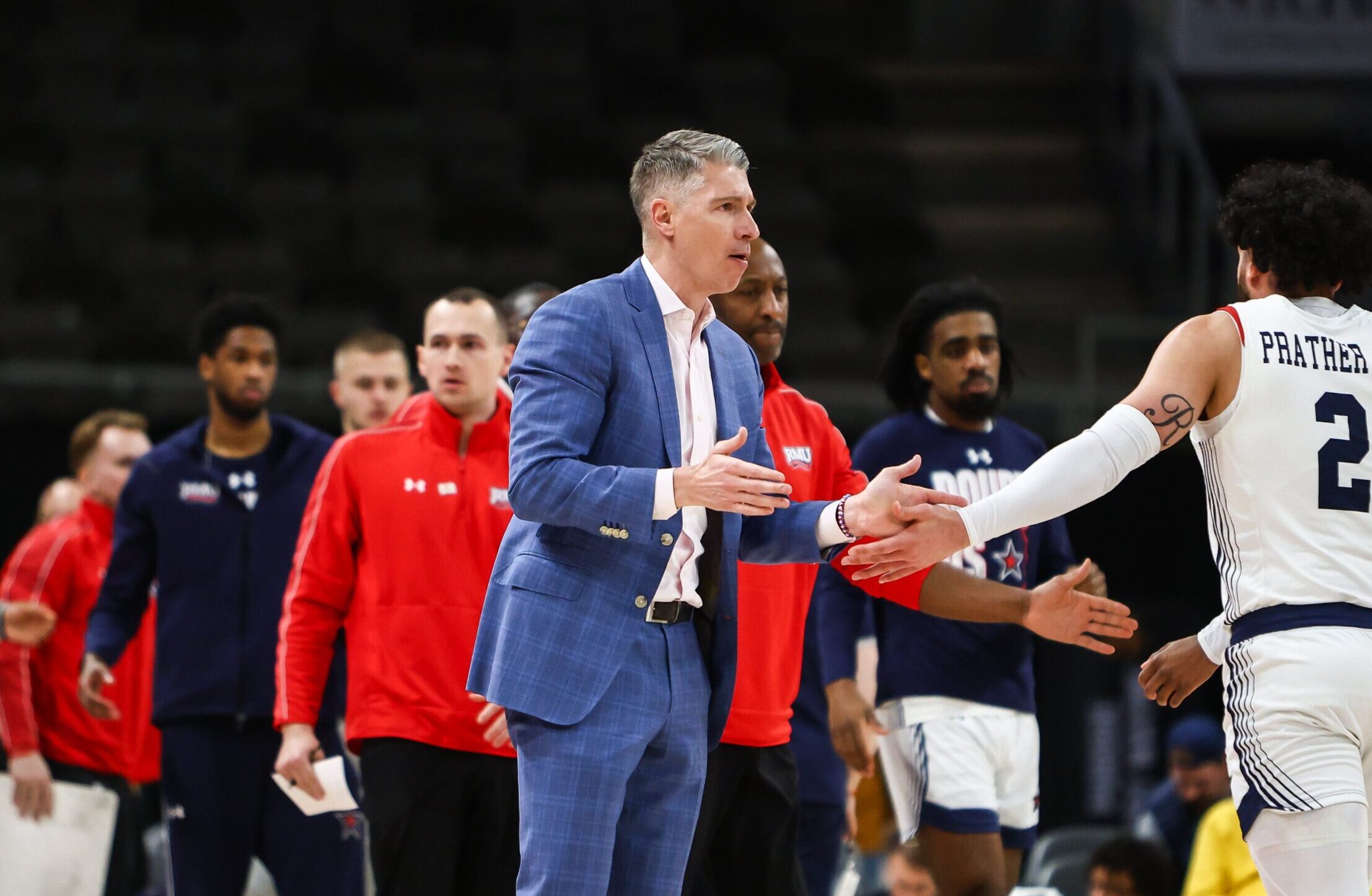 Robert Morris head coach Andy Toole gives a high-five to Ryan Prather Jr. -- RMU Athletics
