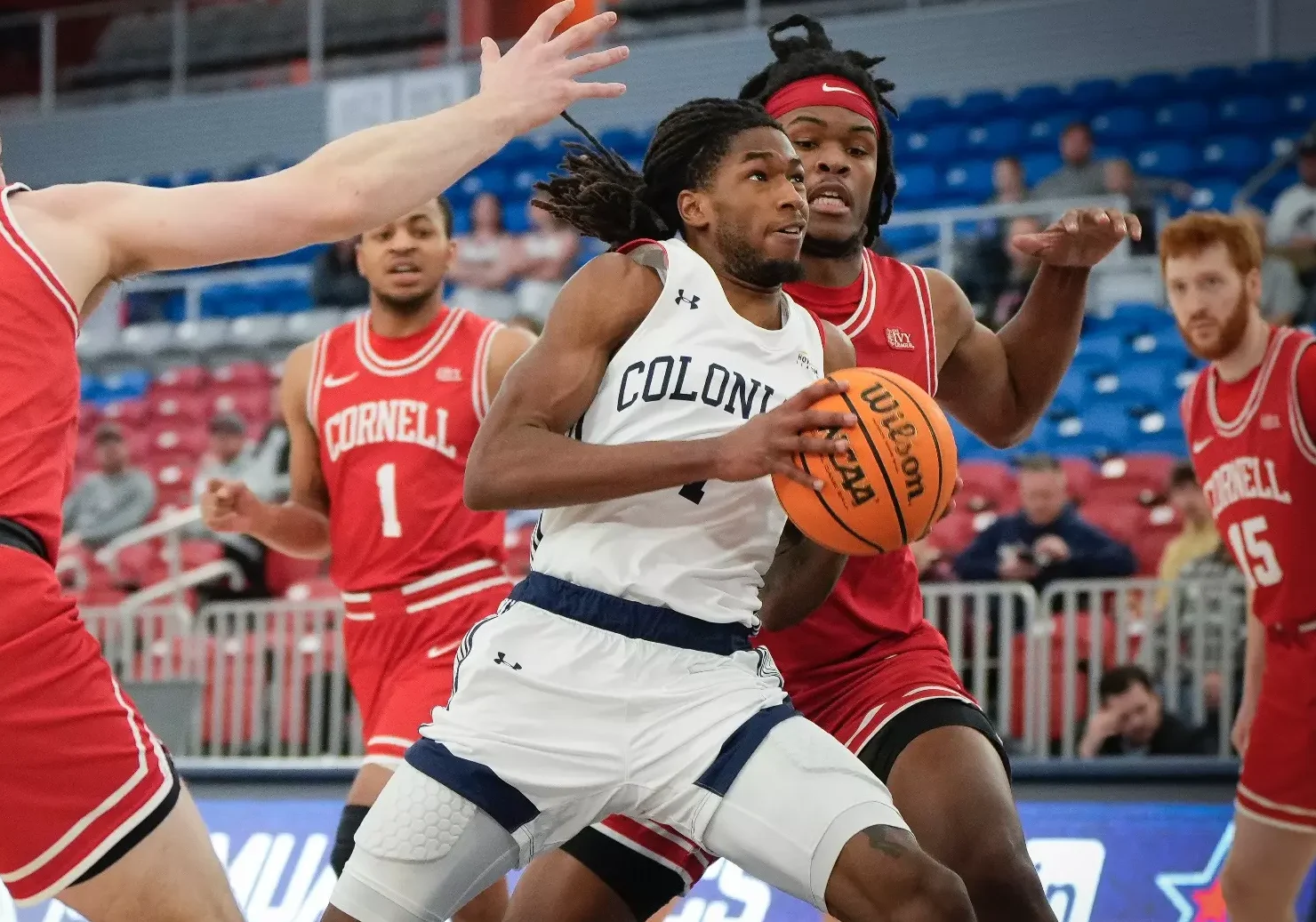 Robert Morris guard Justice Williams drives towards the basket against Cornell during the 2023-24 season -- RMU athletics