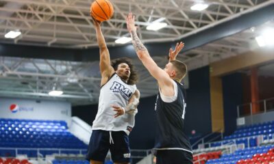 Robert Morris guard Albert Vargas shots a shot over forward Nikos Chitikoudis -- RMU Athletics