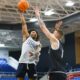 Robert Morris guard Albert Vargas shots a shot over forward Nikos Chitikoudis -- RMU Athletics