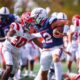Robert Morris quarterback Jake Wolfe stiff arms a Dayton defender on Sept. 20, 2025 -- RMU Athletics