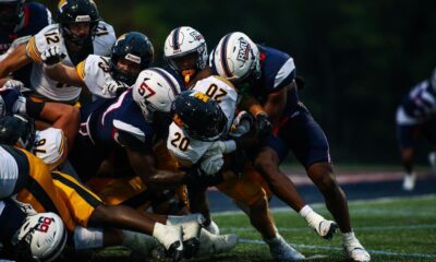 Robert Morris defenders tackle a West Liberty ball carrier on Sept. 13, 2025 -- RMU Athletics