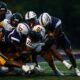 Robert Morris defenders tackle a West Liberty ball carrier on Sept. 13, 2025 -- RMU Athletics