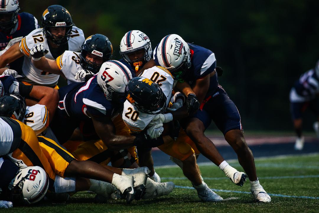 Robert Morris defenders tackle a West Liberty ball carrier on Sept. 13, 2025 -- RMU Athletics