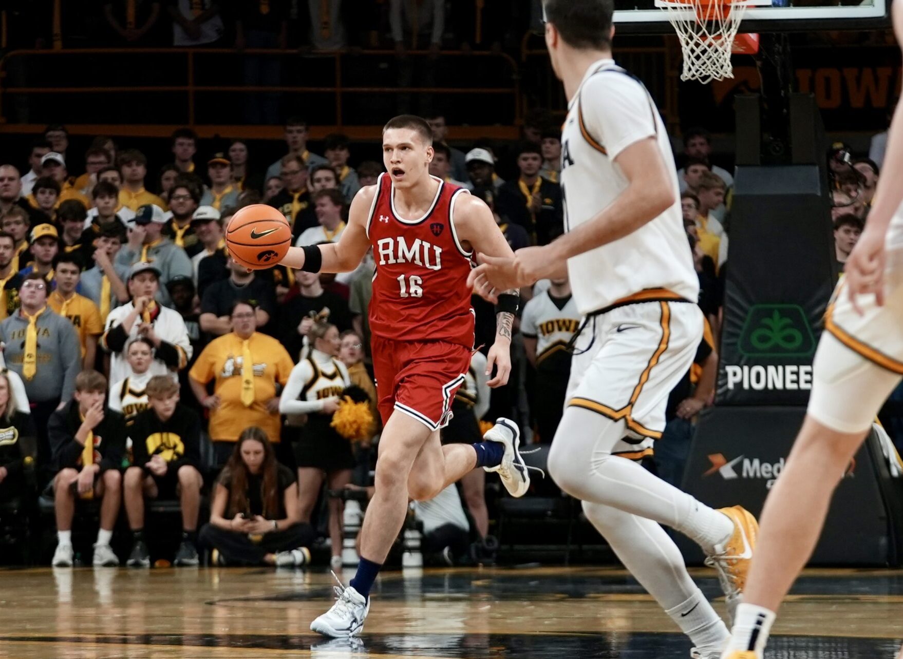 Robert Morris forward Nikolaos Chitikoudis brings the ball up court in front of former Robert Morris, current Iowa forward Alvaro Folgueiras on Nov. 4, 2025 -- RMU Athletics