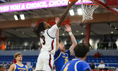 Robert Morris guard Ta'Zir Smith attempts a layup against a Pitt-Greensburg defender on Nov. 13, 2025 -- RMU Athletics
