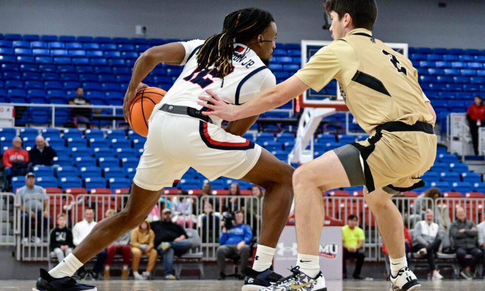 Robert Morris guard Darius Livingston Jr. handles the ball with a Geneva defender guarding him at the UPMC Events Center -- Ed Thompson // Pittsburgh Sports Now
