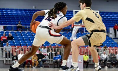 Robert Morris guard Darius Livingston Jr. handles the ball with a Geneva defender guarding him at the UPMC Events Center -- Ed Thompson // Pittsburgh Sports Now