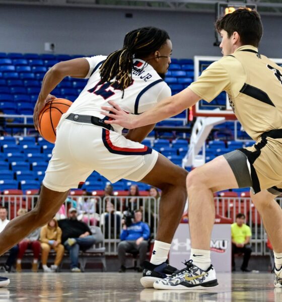 Robert Morris guard Darius Livingston Jr. handles the ball with a Geneva defender guarding him at the UPMC Events Center -- Ed Thompson // Pittsburgh Sports Now