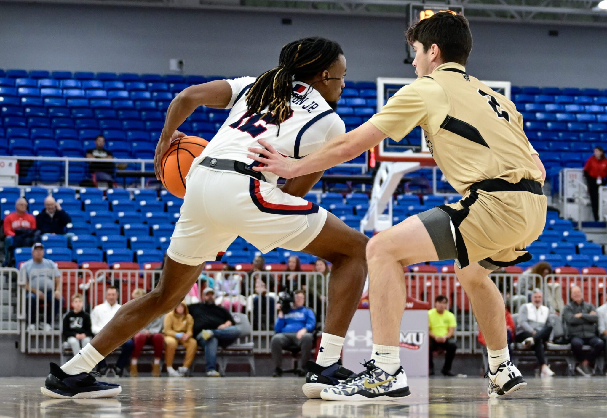Robert Morris guard Darius Livingston Jr. handles the ball with a Geneva defender guarding him at the UPMC Events Center -- Ed Thompson // Pittsburgh Sports Now