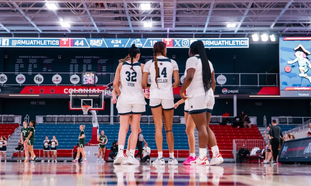 Robert Morris guards Noa Givon and Dania McClain, along with forward Layke Fields, huddle up during a game -- RMU Athletics