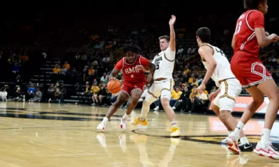 Robert Morris wing Eddie Cooke III drives against an Iowa defender -- RMU Athletics