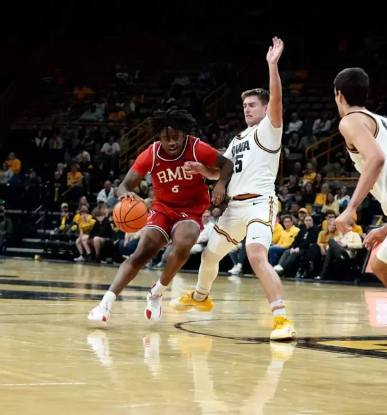 Robert Morris wing Eddie Cooke III drives against an Iowa defender -- RMU Athletics